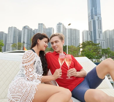 young couple relaxing with champagne and skyline view in modern city
