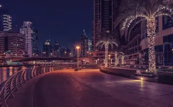 dubai marina waterfront promenade at night with illuminated skyline