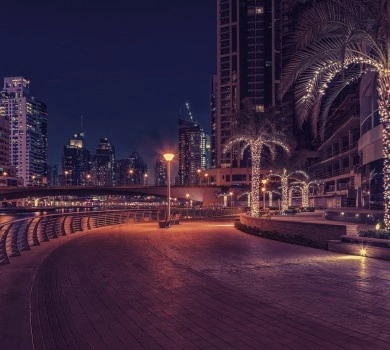 dubai marina waterfront promenade at night with illuminated skyline