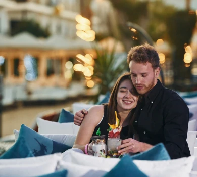 romantic couple enjoying drinks at luxury outdoor restaurant at night