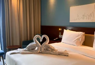 Romantic hotel room in Dubai with towel swans and modern interior