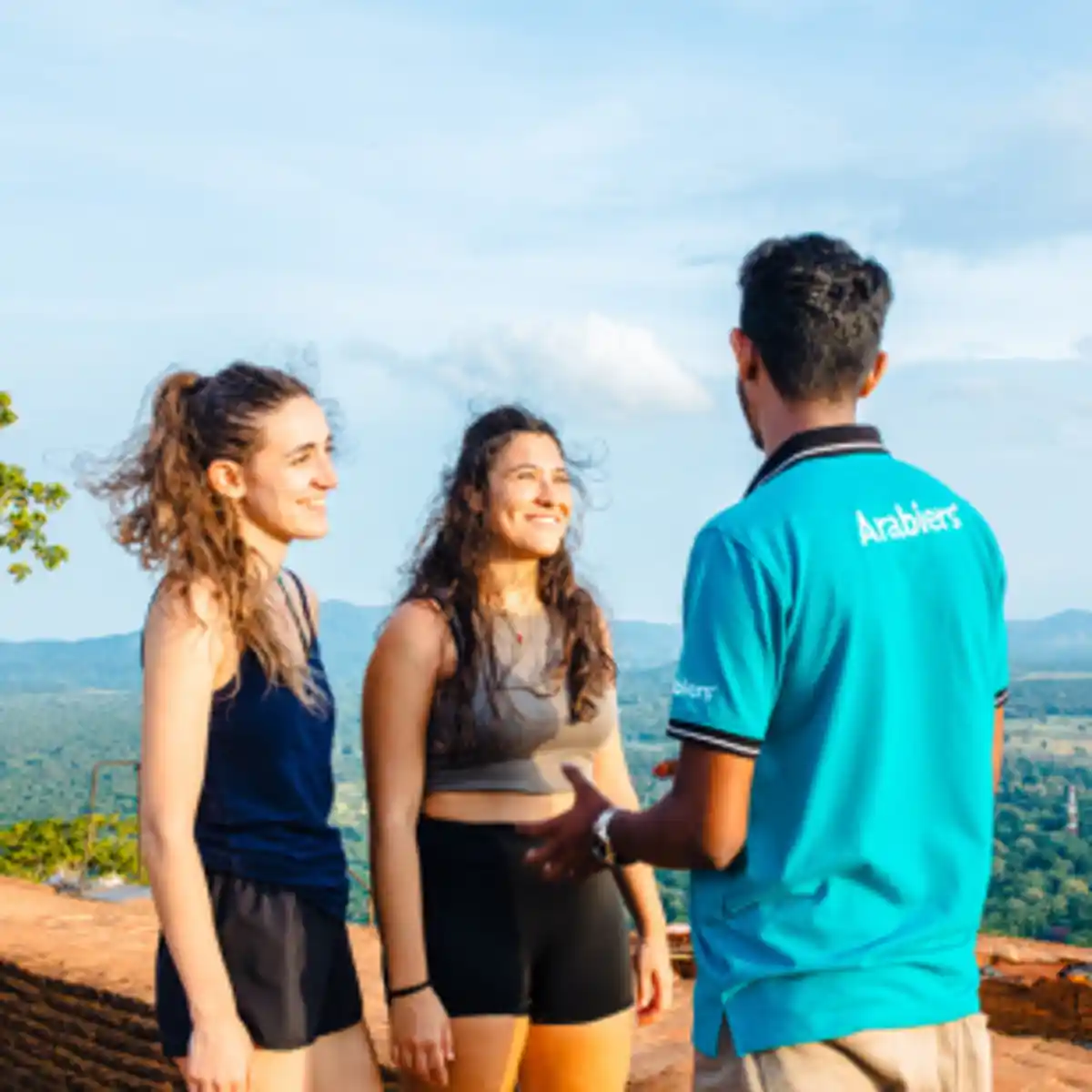 Tour guide talking with travellers at scenic viewpoint