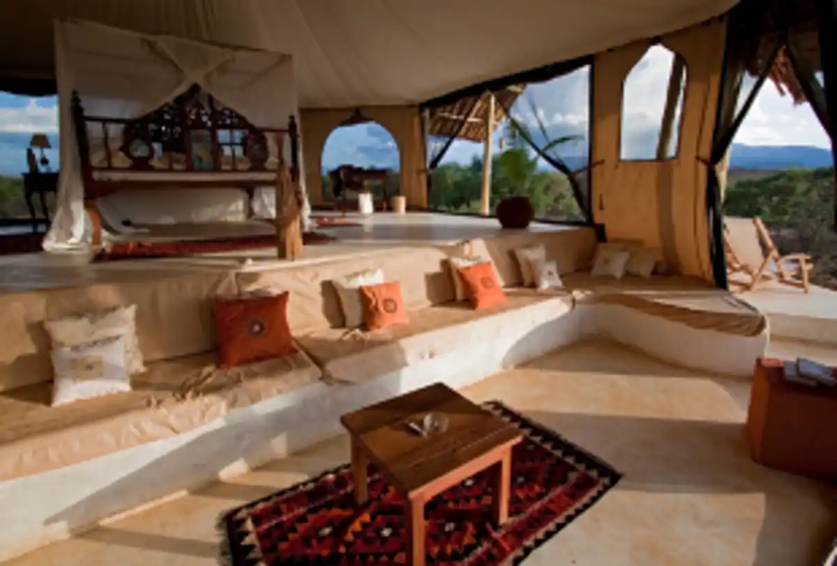 Luxury desert camp tent interior with seating and bed setup