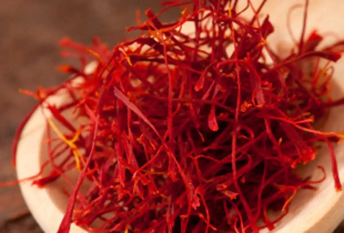 Close-up of premium saffron threads in wooden bowl