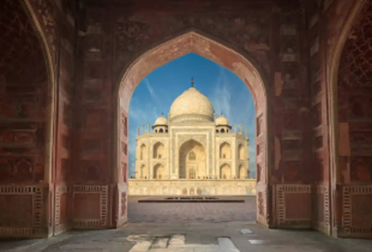 Taj Mahal viewed through Mughal archway in Agra
