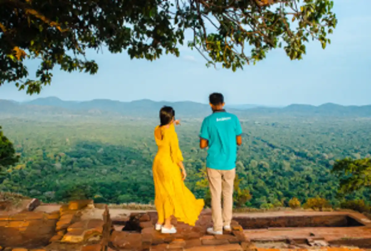Couple and tour guide enjoying mountain viewpoint landscape
