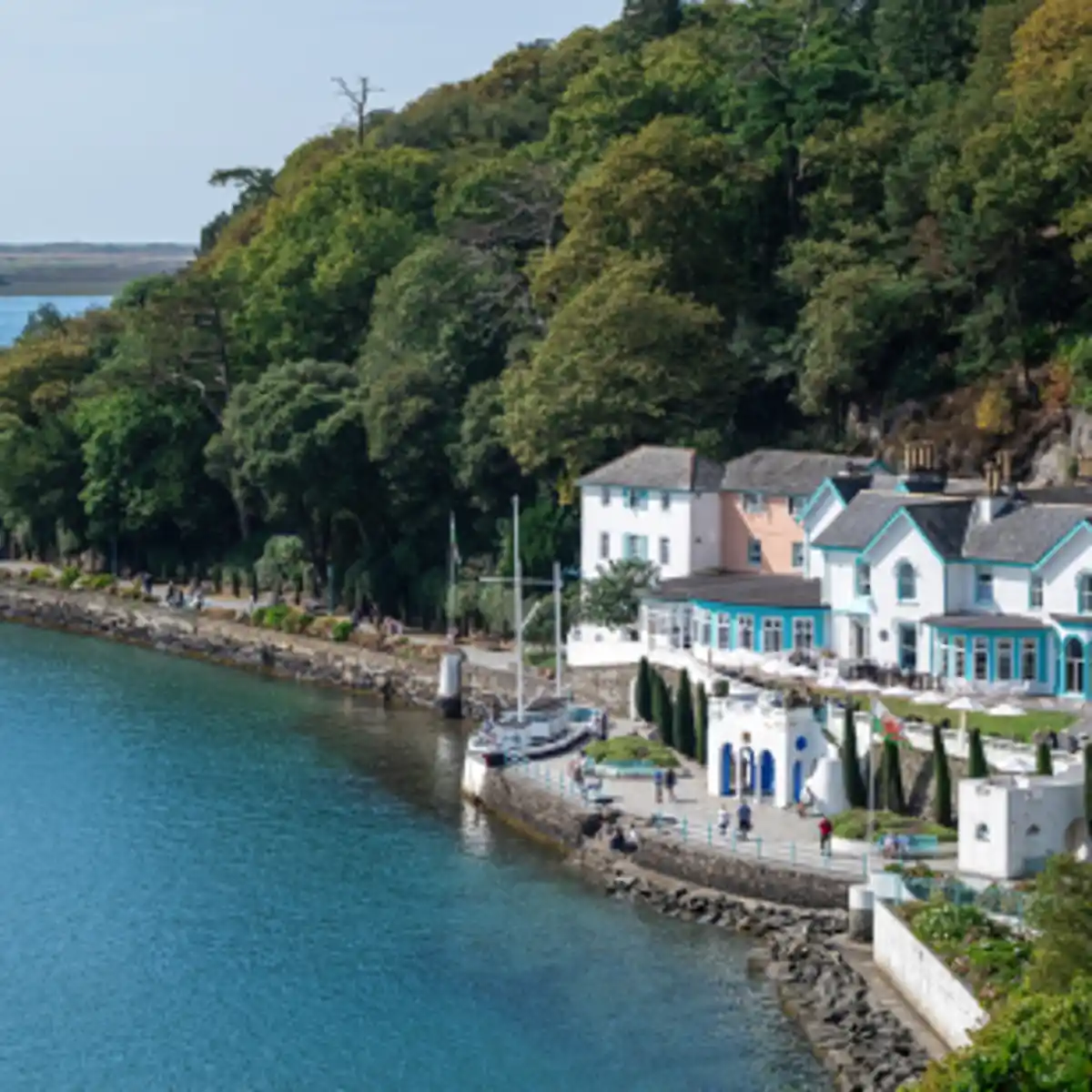Seaside village with waterfront houses and trees along coast