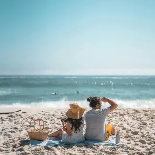 Couple relaxing on tropical Sri Lanka beach looking at ocean