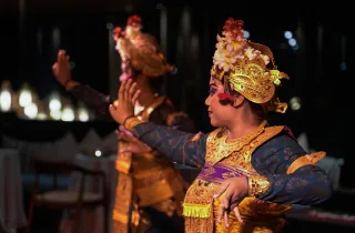 Traditional Sri Lankan dancers performing in ornate costumes at night
