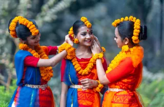 Sri Lankan women in traditional dress with flower garlands during cultural celebration