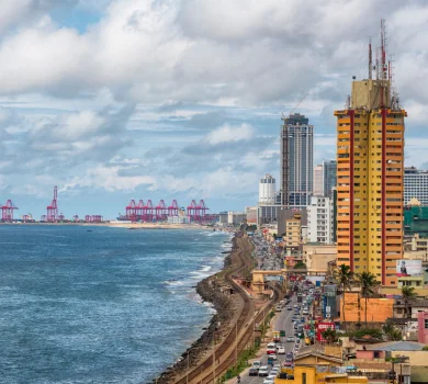 Colombo coastal city skyline with ocean and port cranes