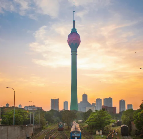 Colombo Lotus Tower at sunset with train tracks and city skyline in Sri Lanka
