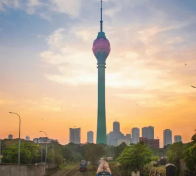Colombo Lotus Tower at sunset with train tracks and city skyline in Sri Lanka